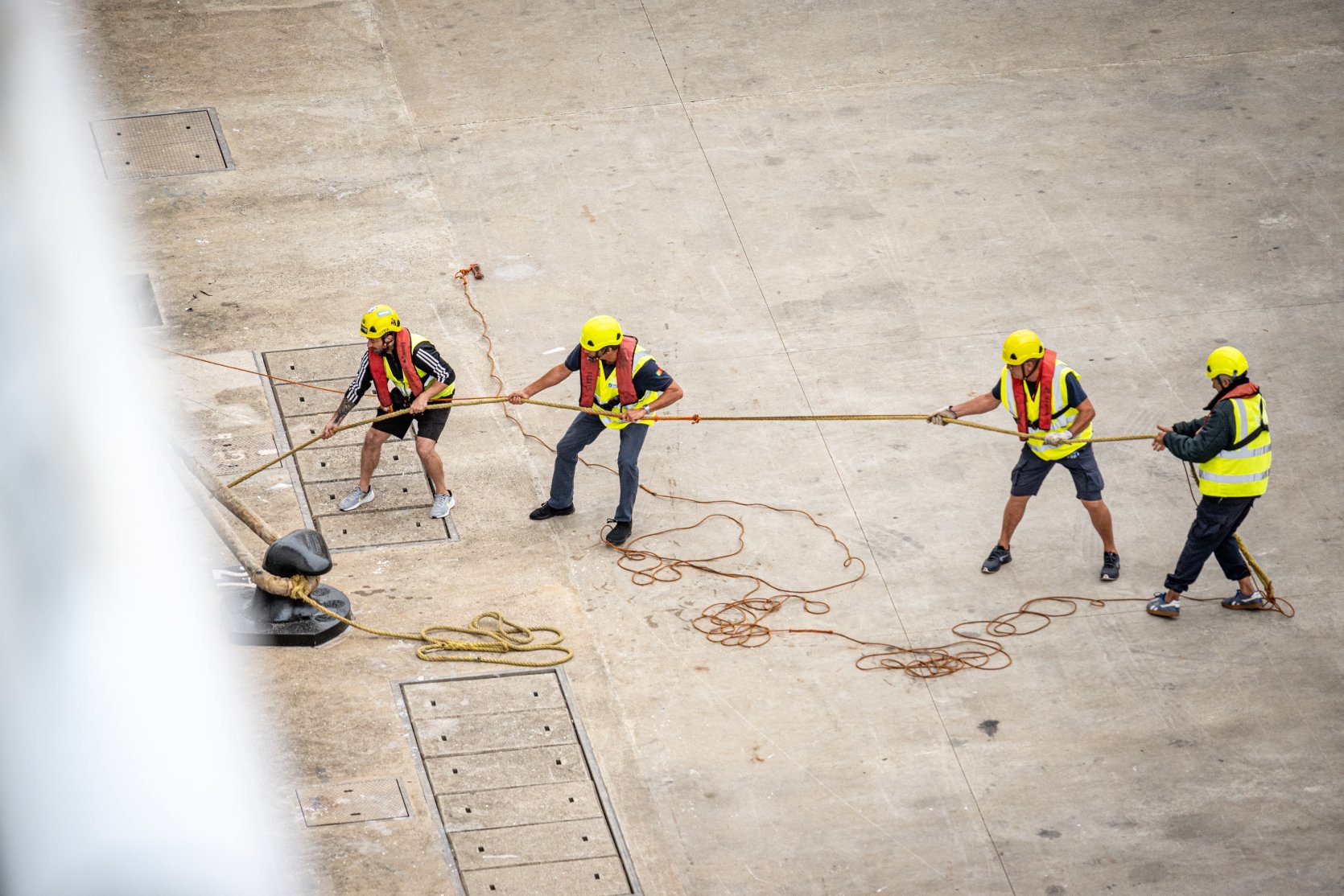 Dock workers pulling ropes